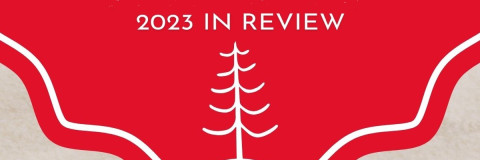 2023 year in Review white text on red background with tree