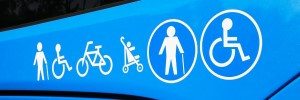 front of a blue bus with accessibility icons